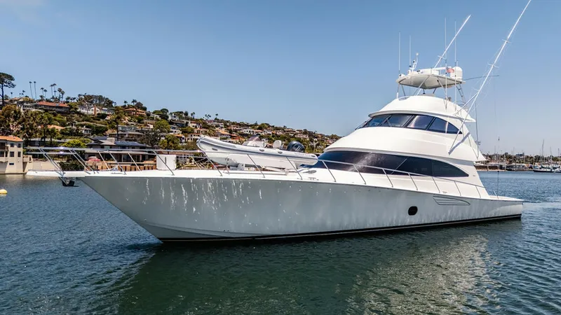 Slide: The Image of Port Side Exterior View The 2019 Viking 80 Skybridge, PARTY OF FIVE, showcases its sleek and powerful design in this port side view. The vessel's elegant lines and expansive flybridge are highlighted against the scenic backdrop. Its robust construction and modern styling make it - 6478776