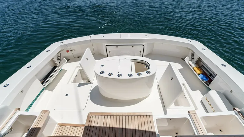 Slide: The Image of Spacious Aft Deck with Fishing Station The aft deck of the 2019 Viking 80 Skybridge features a well-equipped fishing station, complete with rod holders and ample storage. The teak flooring adds a touch of elegance, while the open layout provides plenty of space for activities. This area is per - 6478757