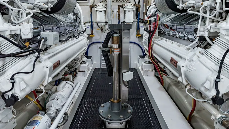 Slide: The Image of Engine Room with Dual Engines This image showcases the meticulously organized engine room of the 2019 Viking 80 Skybridge, 'PARTY OF FIVE'. The room features dual powerful engines, highlighting the advanced engineering and precision craftsmanship. The clean layout and accessible desig - 6478755