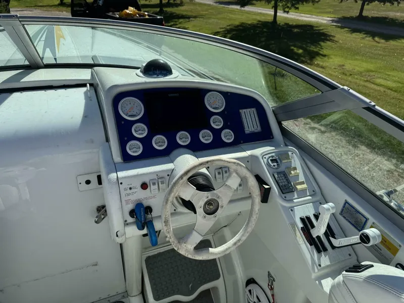 Slide: The Image of Formula 312 FASTech Helm and Gauges Helm station with performance gauges, steering wheel, and navigation electronics on this 1999 Formula 312 FASTech offshore powerboat. - 5945911