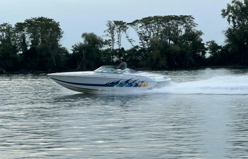 Slide: The Image of 1999 Formula 312 FASTech Exterior Profile – Ira MI Side profile of 1999 Formula 312 FASTech high-performance offshore boat with factory graphics and deep-V hull, offered by Dunigan Marine Group in Michigan. - 5945905