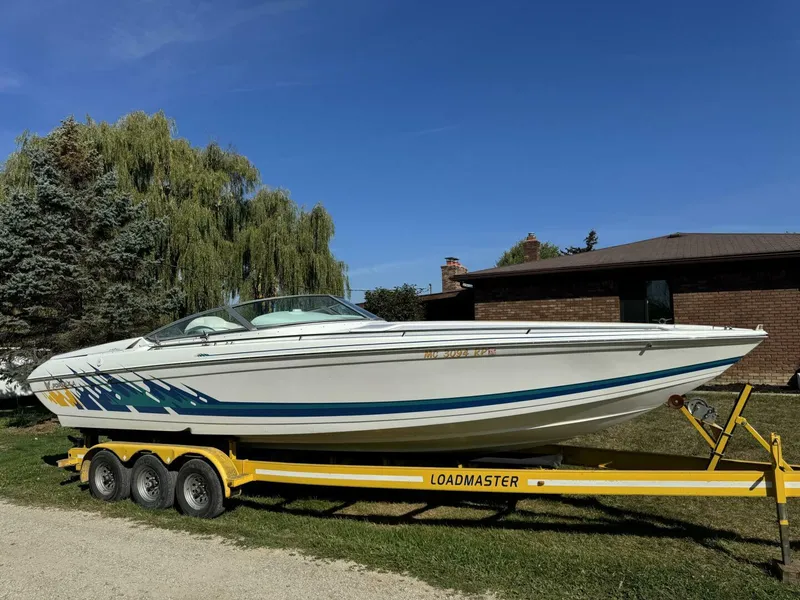 Slide: The Image of 1999 Formula 312 FASTech on Trailer Full view of 1999 Formula 312 FASTech high-performance boat on matching trailer, offered by Dunigan Marine Group Michigan. - 5945914