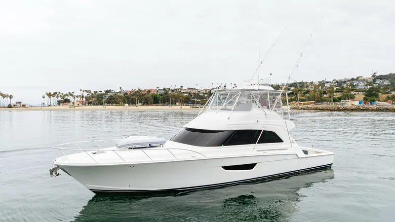 The Image of Side View of Bertram 61 Convertible This image showcases the sleek and powerful profile of the 2020 Bertram 61 Convertible. The yacht's clean lines and robust hull are complemented by a spacious flybridge, ideal for navigating and leisure. The expansive windows provide panoramic views, enha - 8672913