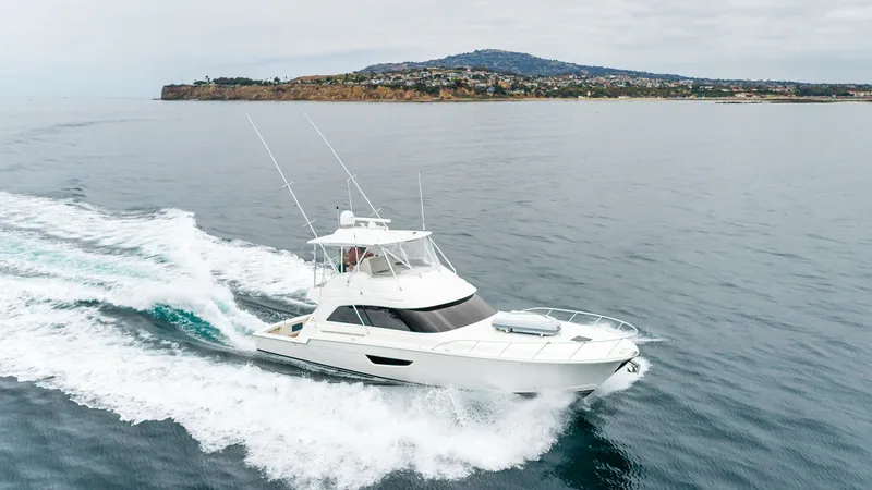 Slide: The Image of Aerial View of SINE METU Cruising The 2020 Bertram 61 Convertible, SINE METU, elegantly cuts through the water, showcasing its sleek design and powerful performance. The flybridge offers a commanding view, while the spacious foredeck is perfect for relaxation. This vessel combines luxury - 8672995