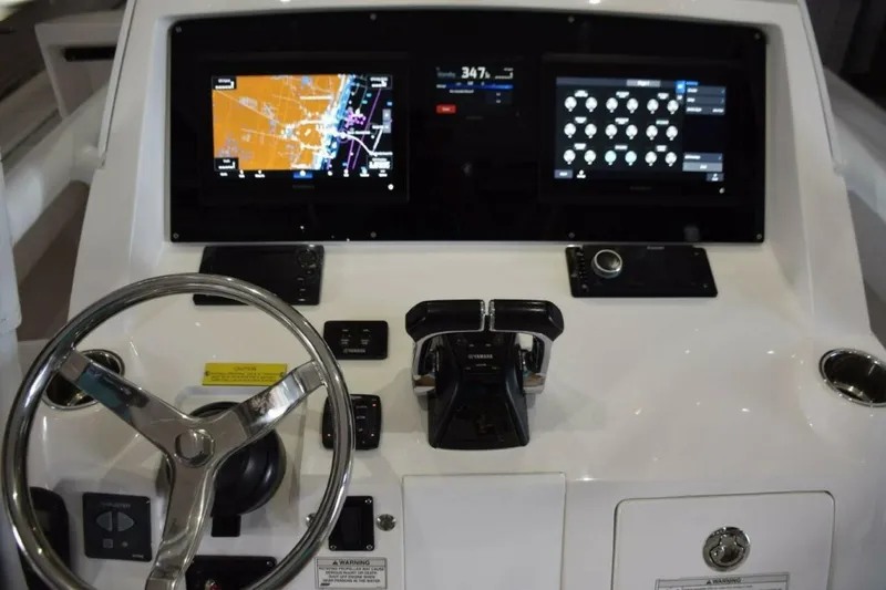Slide: The Image of Dual Garmin 12 Inch Displays With Garmin Autopilot Between. Digital Switching For Boat Systems Via Garmin. - 5972599