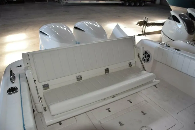 Slide: The Image of Rear Seat Opened, There Is A Receiver On Deck To Move Fiberglass Table Here If Wanted. Note Pop Up Cleats. - 5972602