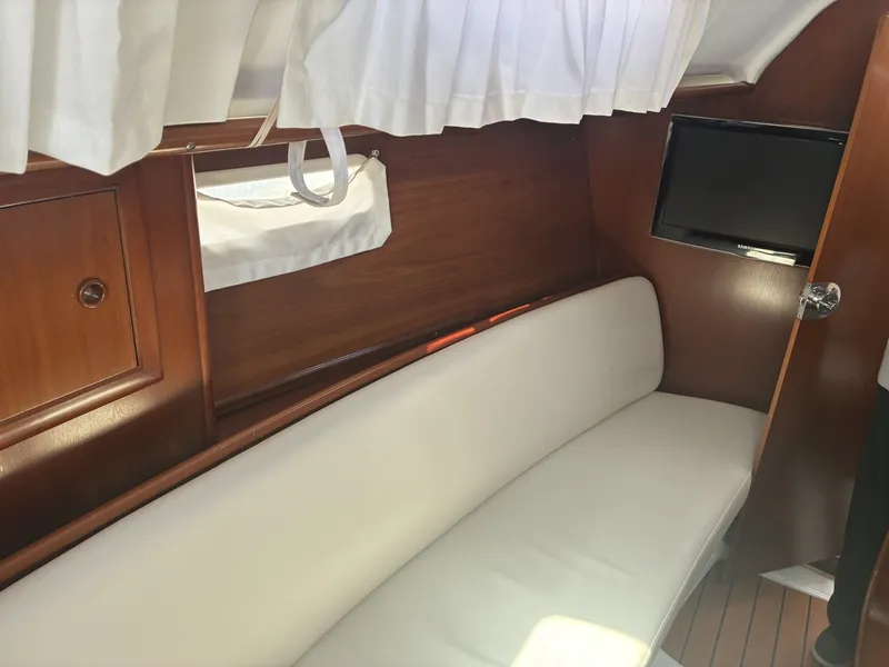 Slide: The Image of 2003 Beneteau Oceanis 311 - Port settee Port settee curtains and television - 5999399