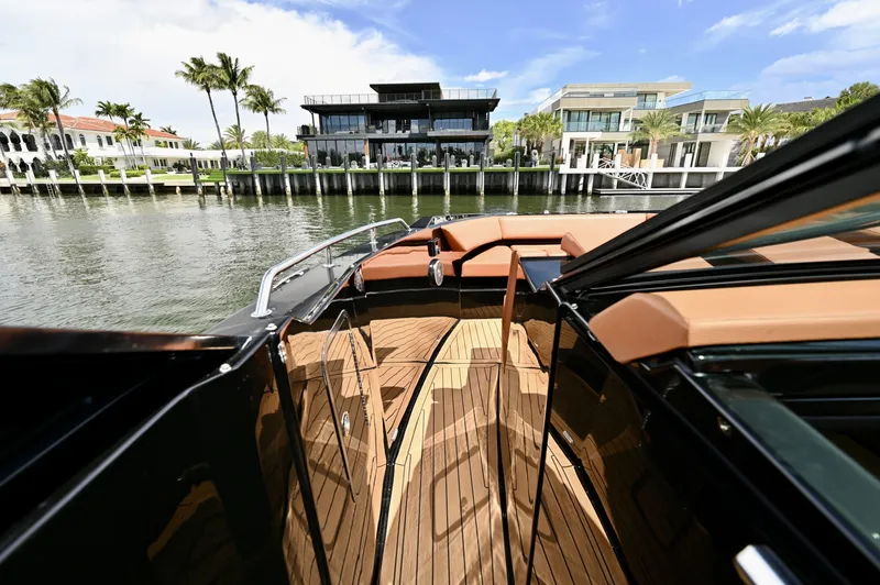 Slide: The Image of Walkthrough to Bow, Cruisers Yachts 38 GLS The walkthrough provides direct and secure access from the helm to the bow seating area. Finished with teak-style decking and bordered by raised coamings, the passage is designed for safe movement while underway or at anchor.
A split windshield opens easi - 6003092