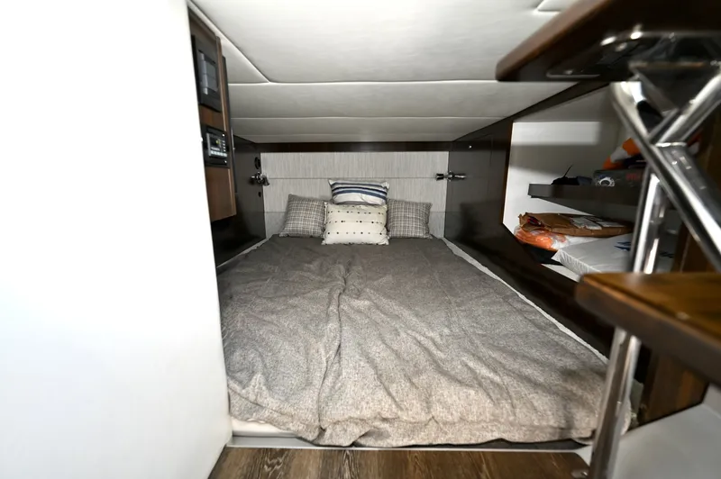 Slide: The Image of Mid Cabin Berth, Cruisers Yachts 38 GLS The mid cabin features a full berth designed for overnight accommodations, offering a private and comfortable sleeping space below deck. The layout maximizes available volume, providing adequate headroom for access and a practical arrangement for extended - 6003105