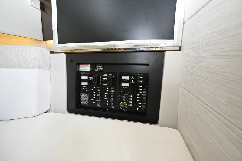 Slide: The Image of Electrical Distribution Panel, Cruisers Yachts 38 GLS The electrical distribution panel is centrally located within the cabin, providing organized access to both AC and DC systems. Clearly labeled breakers and digital readouts allow for straightforward monitoring and control of onboard power.
The layout sepa - 6003107