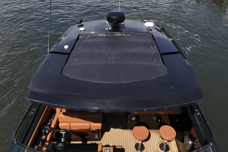Slide: The Image of This overhead view highlights the clean layout of the Cruisers Yachts 38 GLS, featuring a retractable shade system extending from the hardtop to provide additional coverage over the cockpit. The design enhances comfort while maintaining an open-air feel w - 6003113