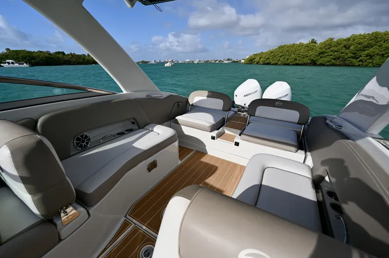 Slide: The Image of Spacious cockpit with wraparound seating, teak-style decking, and open sightlines aft. Comfortable layout for entertaining with easy flow to the swim platform and twin outboards. - 6024940