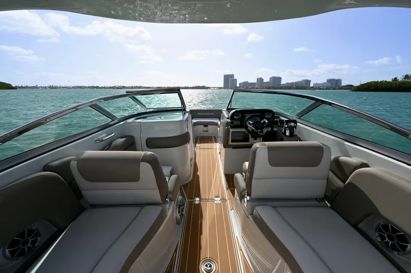 Slide: The Image of Wide center walkthrough to the bow with dual helm seating, clean dash layout, and teak-style flooring. Open design offers excellent visibility and easy movement throughout the boat. - 6024941