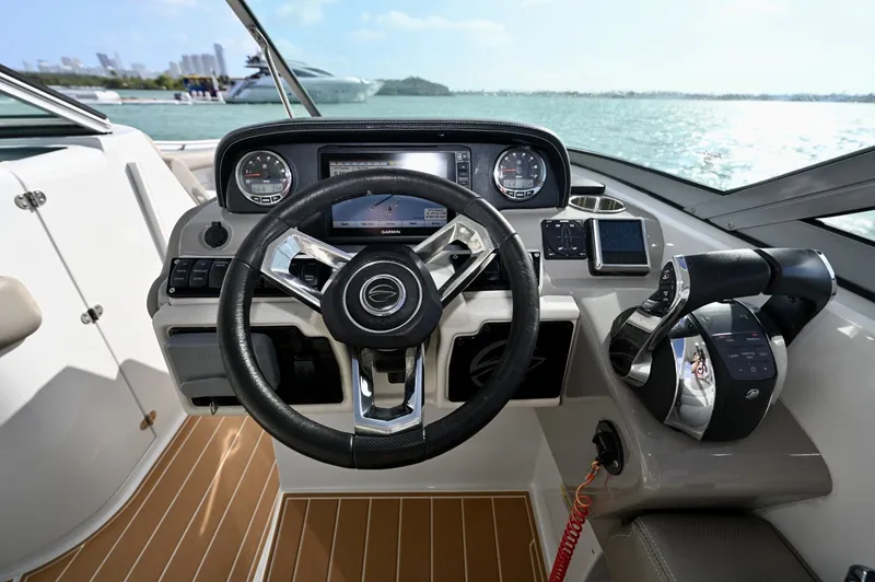 Slide: The Image of Well-appointed helm with Garmin display, analog gauges, and Mercury digital throttle and shift. Intuitive layout with precise control and excellent visibility for confident handling. - 6024943