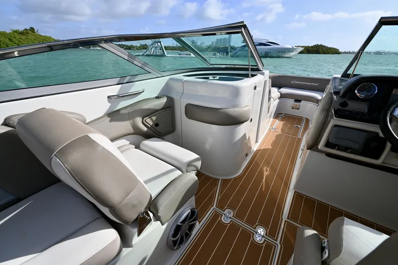 Slide: The Image of Portside console with enclosed head, forward access, and teak-style flooring. Companion seating and open walkway provide comfort and easy movement throughout the cockpit. - 6024945