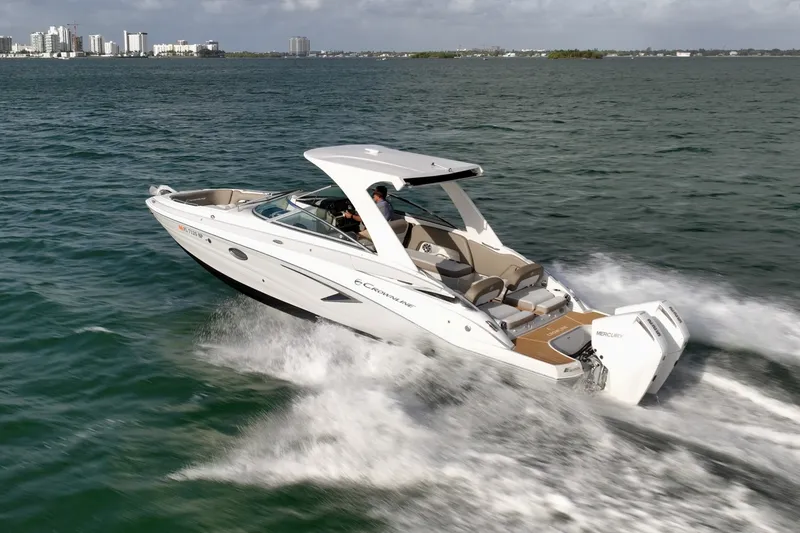 Slide: The Image of Crownline E305 XS powered by twin 225hp Mercury outboards. Spacious bow and cockpit seating, hardtop shade, swim platform, and onboard head. Ideal for cruising, sandbar stops, and watersports. Crownline E305 XS powered by twin 225hp Mercury outboards. Spacious bow and cockpit seating, hardtop shade, swim platform, and onboard head. Ideal for cruising, sandbar stops, and watersports. - 6024931