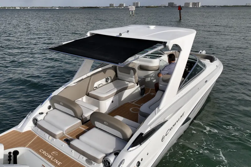 Slide: The Image of Hardtop with retractable sunshade provides flexible shade coverage over the cockpit. Spacious layout with premium seating and teak-style decking offers comfort for cruising and entertaining. - 6024953