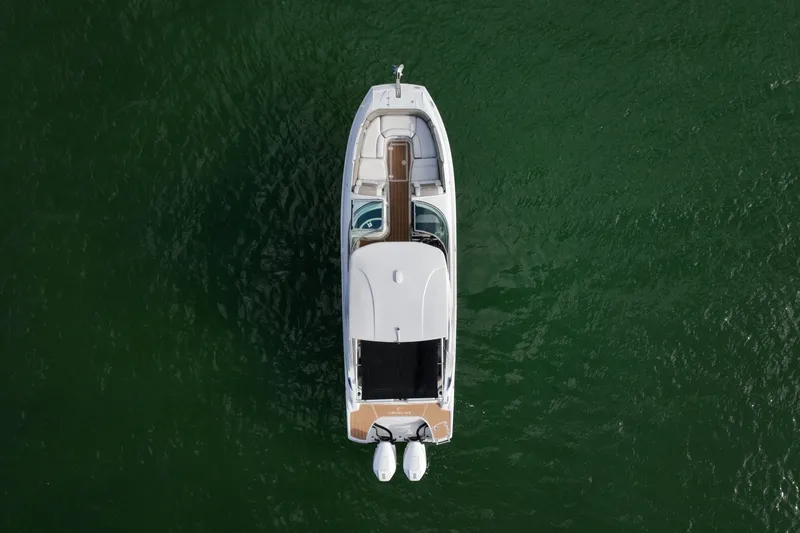 Slide: The Image of Aerial view highlights the full layout from bow to stern, featuring open seating areas, center walkthrough, hardtop with shade, and twin Mercury outboards for balanced performance. - 6024954