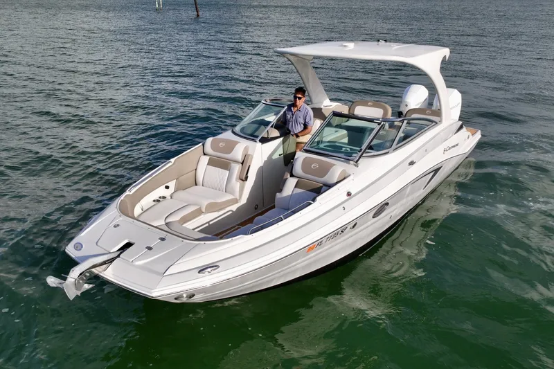 Slide: The Image of Crownline E305 XS Crownline E305 XS with twin 225hp Mercury outboards. Spacious seating, hardtop shade, swim platform, and onboard head. Perfect for cruising, sandbars, and entertaining on the water - 6024934