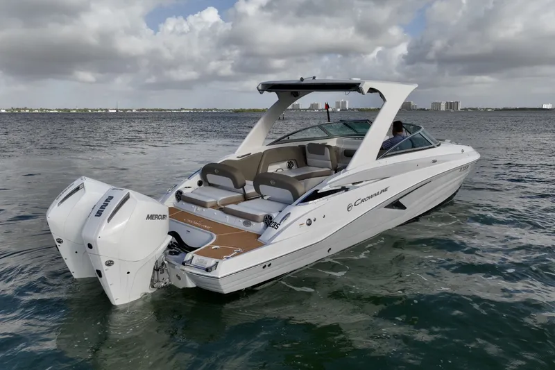 Slide: The Image of Crownline E305 XS with twin 225hp Mercury outboards. Spacious seating, hardtop shade, swim platform, and onboard head. Perfect for cruising, sandbars, and entertaining on the water. - 6024936