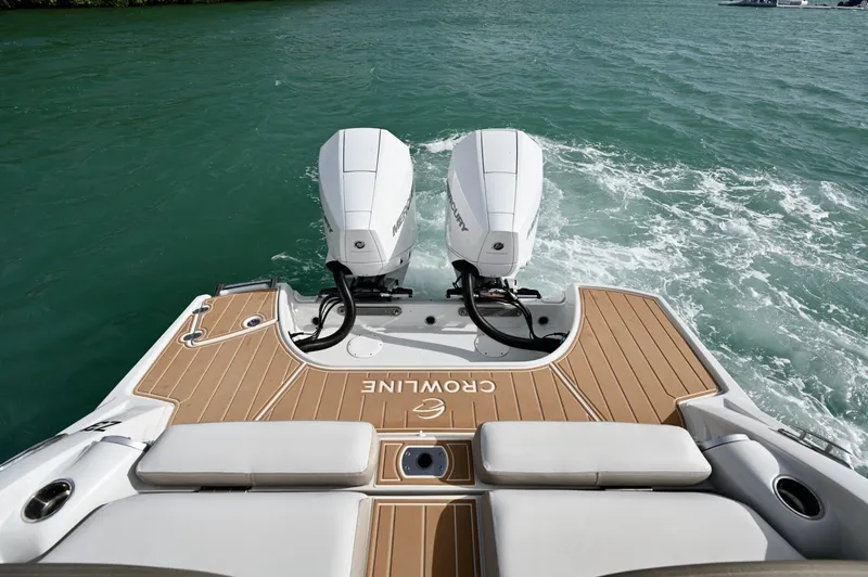 Slide: The Image of Spacious aft swim platform with teak-style decking, twin Mercury outboards, and easy water access. Ideal for swimming, relaxing, and boarding with comfortable aft seating and clean layout. - 6024938