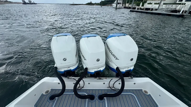 Slide: The Image of Triple Outboard Engines View This image showcases the powerful triple Mercury outboard engines on the 2016 Midnight Express 39S Cuddy. The engines provide exceptional performance and speed, ideal for thrilling open-water adventures. The sleek design of the engine covers complements t - 6311149