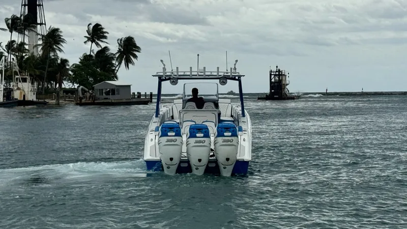 Slide: The Image of Aft View with Quad Outboards This image showcases the powerful aft section of the 2016 Midnight Express 39S Cuddy, featuring four robust outboard engines. The sleek, sporty design ensures high performance and efficiency on the water. The spacious layout provides ample room for maneuv - 6311150