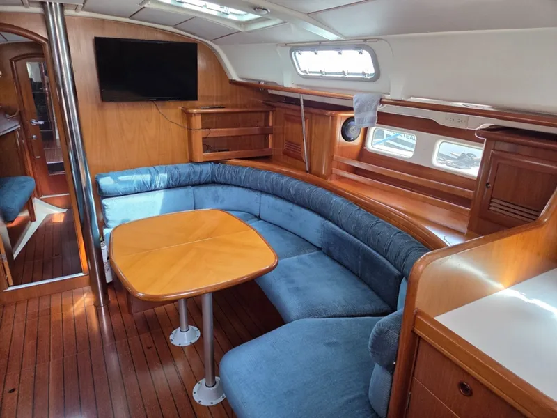 Slide: The Image of Interior of 2000 Beneteau Oceanis 411 yacht with blue cushions and table - 6257945