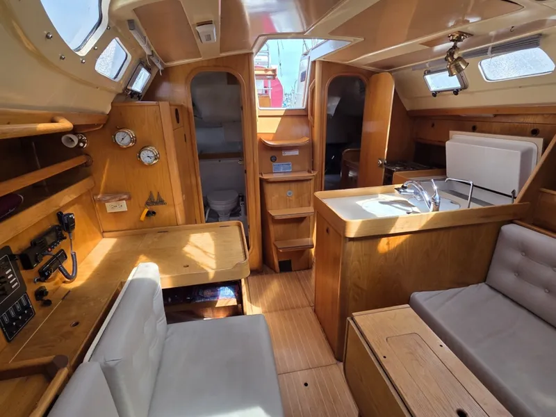 Slide: The Image of Interior of 1988 Beneteau Oceanis 350 with wooden finishes looking aft - 6257971
