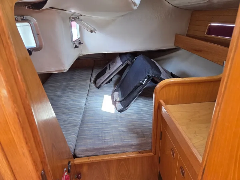 Slide: The Image of Beneteau Oceanis 350 spacious aft primary berth with storage and shelves - 6257962