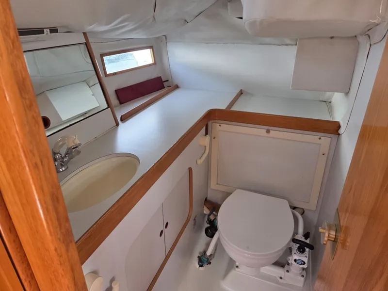 Slide: The Image of Interior of 1988 Beneteau Oceanis 350 head with sink, toilet, and shower head - 6257964