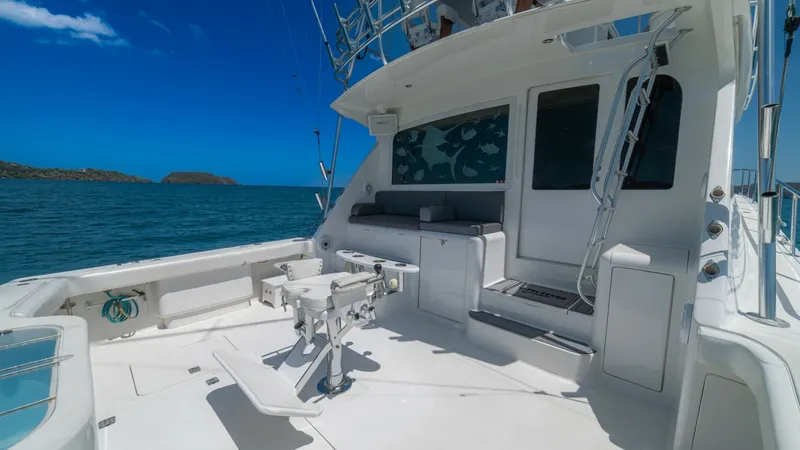 Slide: The Image of Spacious Aft Deck with Fishing Station The aft deck of the 2005 Viking 61 Convertible 'Honey Girl' features a well-equipped fishing station, perfect for avid anglers. The area offers ample seating and storage, with a durable non-slip deck for safety during excursions. The view from the deck pr - 6449554