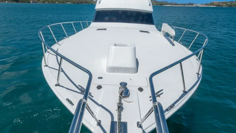 Slide: The Image of Expansive Bow with Anchor System The bow of the 2005 Viking 61 Convertible 'Honey Girl' showcases a spacious deck with a sturdy anchor system, ideal for secure mooring. Stainless steel railings provide safety and style, while the hatch offers easy access to below-deck storage. The sleek - 6449580