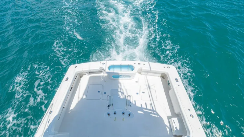 Slide: The Image of Spacious Cockpit with Tackle Center The cockpit of the 2005 Viking 61 Convertible 'Honey Girl' is generously sized, offering ample space for fishing and entertaining. Equipped with a well-organized tackle center and rod holders, it caters to serious anglers. The clean layout and robust cons - 6449561
