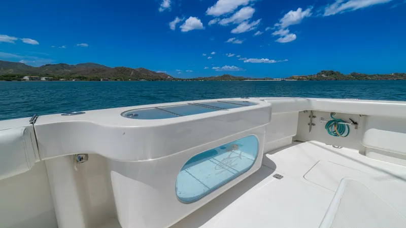 Slide: The Image of Spacious Cockpit with Baitwell The cockpit of the 2005 Viking 61 Convertible 'Honey Girl' features a spacious layout, ideal for fishing enthusiasts. A prominent baitwell with a clear viewing panel is integrated for easy access and monitoring. The sleek, non-slip deck ensures safety whi - 6449560