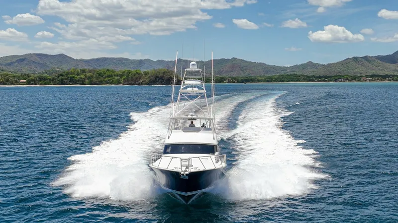 Slide: The Image of Bow View Cruising at High Speed Experience the power and elegance of the 2005 Viking 61 Convertible as it slices through the water with precision. The vessel's sleek design and robust build are highlighted in this dynamic bow view, showcasing its impressive performance. The wake trailin - 6449596
