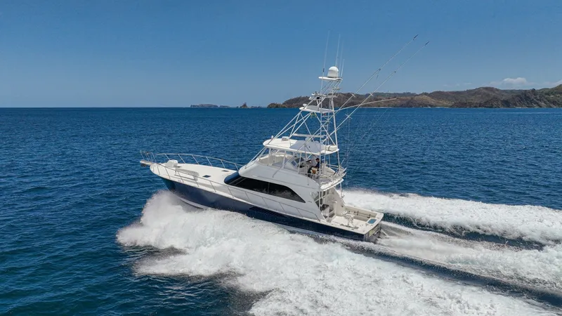 Slide: The Image of Viking 61 Convertible Cruising at Sea The 2005 Viking 61 Convertible, 'Honey Girl', is captured slicing through the water with elegance and power. Its sleek design is complemented by a spacious flybridge and robust outriggers, ideal for sportfishing enthusiasts. The vessel's performance is ev - 6449599