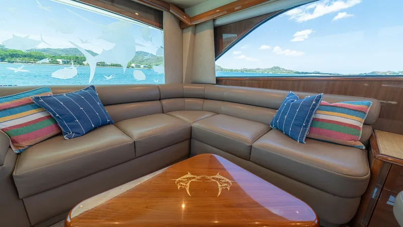 Slide: The Image of Salon Seating with Scenic Views This inviting salon area features a plush L-shaped leather sofa, perfect for relaxation and entertaining. The large windows offer breathtaking views of the surrounding seascape, enhancing the sense of openness and connection to the water. A stylish wooden - 6449511