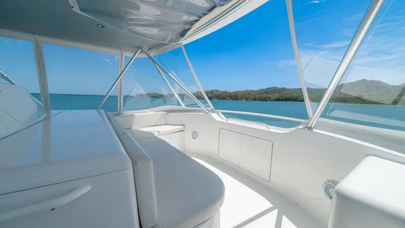 Slide: The Image of Flybridge Seating with Panoramic Views Experience the open-air luxury of the Viking 61 Convertible's flybridge, featuring spacious seating with plush cushions and expansive panoramic views. The elegant design allows for comfortable lounging while enjoying the surrounding seascape. Large window - 6449574