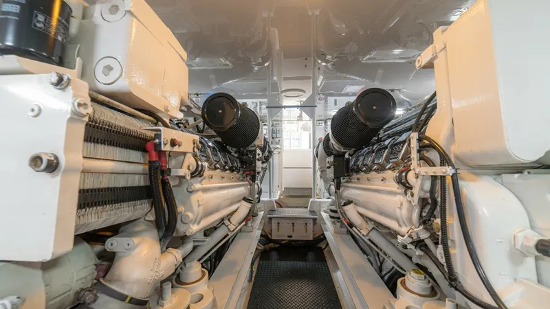Slide: The Image of Engine Room with Dual Engines This image showcases the meticulously maintained engine room of the 2005 Viking 61 Convertible. Featuring dual powerful engines, the space is designed for optimal performance and efficiency. The well-organized layout and clean environment highlight the ve - 6449550