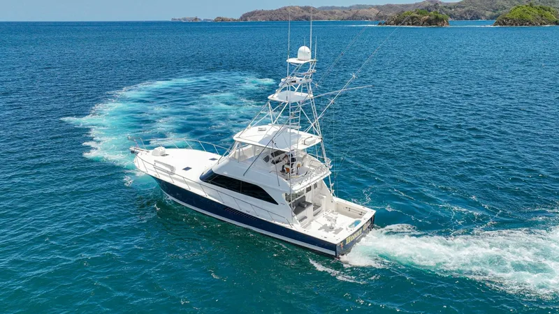 Slide: The Image of Aerial View of Viking 61 Convertible This image showcases the Viking 61 Convertible, highlighting its sleek design and spacious aft deck. The vessel cuts smoothly through the water, demonstrating its powerful performance and stability. The tower is equipped with advanced navigation and commu - 6449592