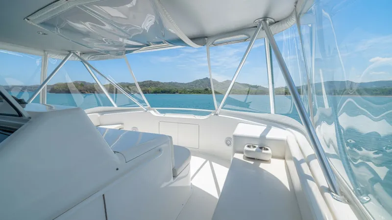 Slide: The Image of Enclosed Flybridge with Panoramic Views This enclosed flybridge on the 2005 Viking 61 Convertible offers expansive panoramic views with its large windows. The seating area is comfortably arranged, providing an ideal vantage point for navigation and relaxation. The clean, white finishes and ampl - 6449573