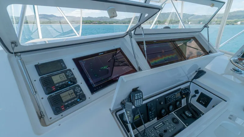Slide: The Image of Flybridge Helm Station The flybridge helm station of the 2005 Viking 61 Convertible features advanced navigation and communication equipment. Large multi-function displays provide clear visuals for navigation and fish-finding, while the array of controls and gauges are intuitiv - 6449568