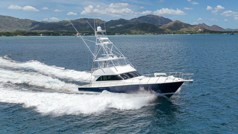 Slide: The Image of Viking 61 Convertible in Motion The 2005 Viking 61 Convertible, 'Honey Girl', cuts through the water with precision, showcasing its sleek hull design and powerful performance. The flybridge tower provides excellent visibility, perfect for navigation and sport fishing. This vessel's robu - 6449594