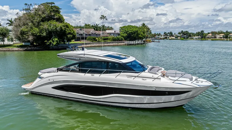 The Image of Side Profile of 2026 Princess V55 This image showcases the sleek side profile of the 2026 Princess V55, emphasizing its elegant lines and modern design. The expansive windows along the hull provide ample natural light and stunning views for those onboard. The streamlined hardtop and spaci - 6312322