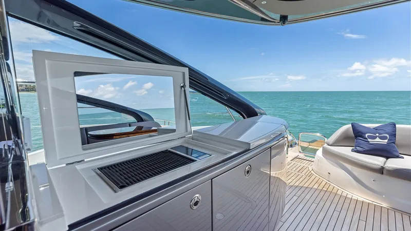 Slide: The Image of Cockpit Grill Station The cockpit deck of the 2026 PRINCESS V55 offers a luxurious outdoor living space with a sleek, integrated grill station perfect for alfresco dining. The expansive teak decking provides a sophisticated and durable finish, while the comfortable seating are - 6312335