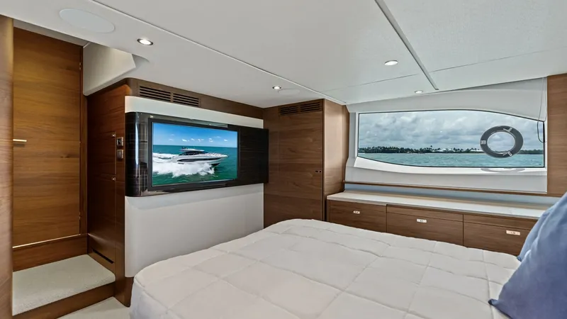 Slide: The Image of Master Stateroom with Ocean View The luxurious master stateroom of the 2026 Princess V55 offers a serene escape with its elegant design and premium finishes. A large window provides breathtaking ocean views, while the integrated flat-screen TV ensures entertainment at your fingertips. Th - 6312349