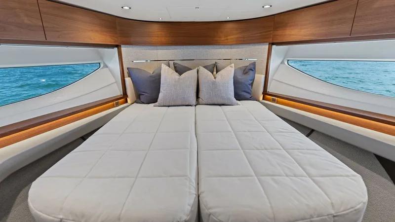 Slide: The Image of Spacious Forward Stateroom This elegant forward stateroom on the 2026 PRINCESS V55 offers a luxurious sleeping arrangement with twin berths that can convert into a double bed. The space is adorned with rich wood finishes and large panoramic windows, allowing natural light to enhanc - 6312353