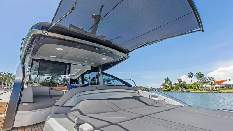 Slide: The Image of Spacious Cockpit Deck Sunshade and Sun Lounger The 2026 PRINCESS V55 features a luxurious cockpit deck with a large sunshade and sun lounger, perfect for soaking up the sun. The retractable sunshade provides comfort and versatility, allowing you to enjoy the outdoors in any weather. Sleek modern seati - 6312362