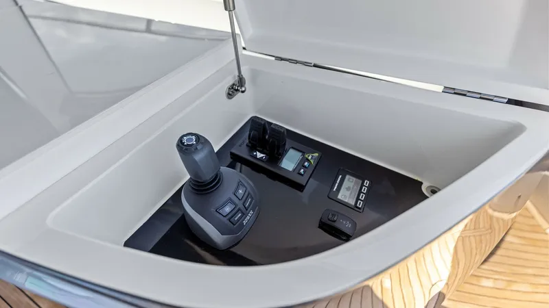 Slide: The Image of Joystick Control Station This image features the joystick control station of the 2026 PRINCESS V55. The station is neatly housed within a compartment, showcasing advanced navigation controls that ensure smooth and precise maneuvering. The sleek design and modern technology enhanc - 6312363
